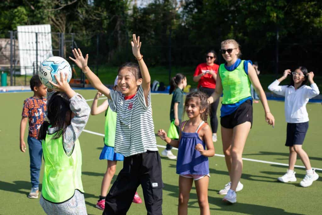 Children playing dodgeball on the astroturf at our holiday club, enjoying active outdoor activities