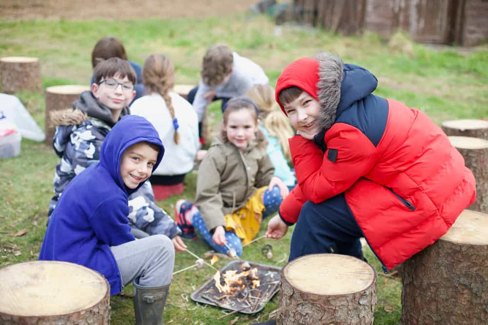 Children having fun at Educamps February Half Term Camp building campfires